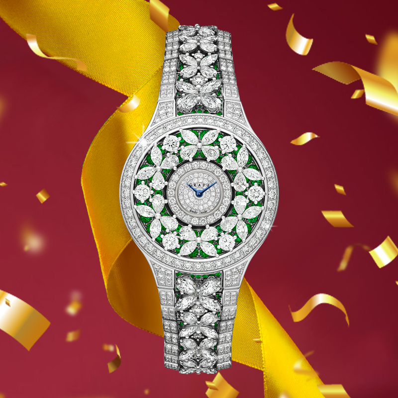 Часы Graff Butterfly в 32 мм корпусе из белого золота. Корпус и браслет украшены изумрудами и бриллиантами